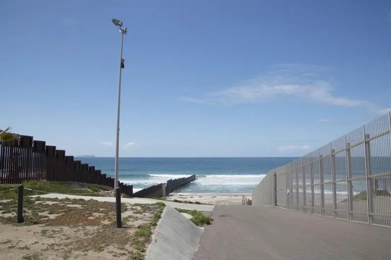A section of the border wall extending into the Pacific Ocean near San Diego. Photo by Donna Burton