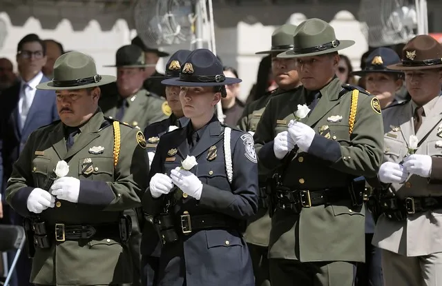 CBP Honor Guard holding white roses
