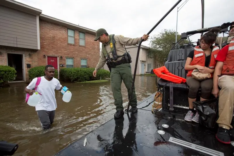 U.S. Border Patrol riverine agents evacuate residents from a flooded Houston neighborhood after Hurricane Harvey August 30. Photo Credit: Glenn Fawcett          