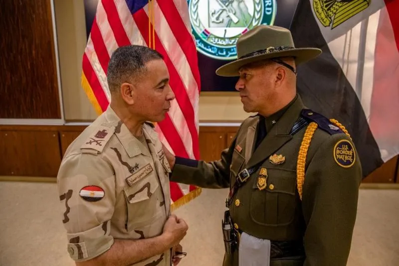 Mahmoud Hassenin, Egyptian defense attaché to the U.S. and Carlos Ortiz, U.S. Border Patrol Academy acting deputy chief patrol agent, confer during the Egyptian border guard graduation.