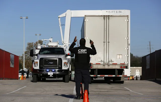 A field operations officer guides a CBP x-ray inspection during inspections of commercial vehicles as they arrive at NRG stadium in preparation for Super Bowl LI in Houston, Texas. Photo Credit: Glenn Fawcett