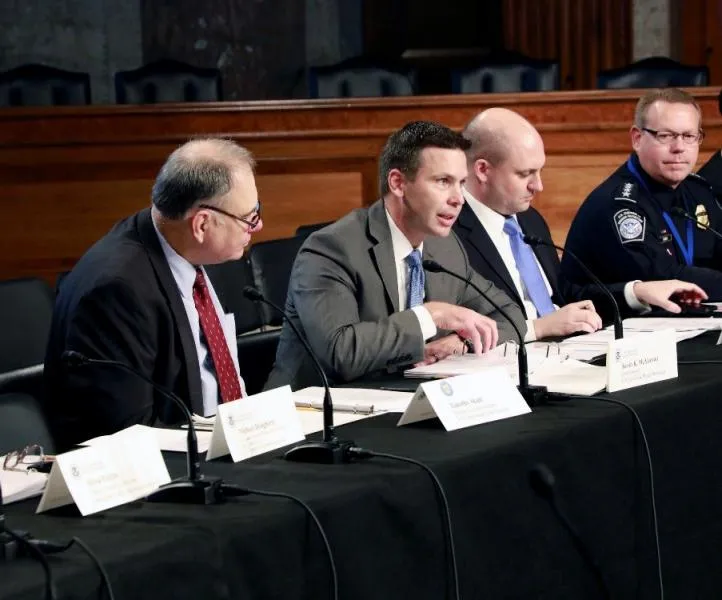CBP Commissioner Kevin K. McAleenan, center left, delivers his opening remarks at the October 3, 2018 COAC meeting in Washington, D.C.  From left, Deputy Assistant Treasury Secretary Timothy Skud, CBP Executive Director of Trade Relations Bradley Hayes, and CBP Executive Assistant Commissioner Office of Field Operations Todd Owen.  Photo Credit: Jaime Rodriguez
