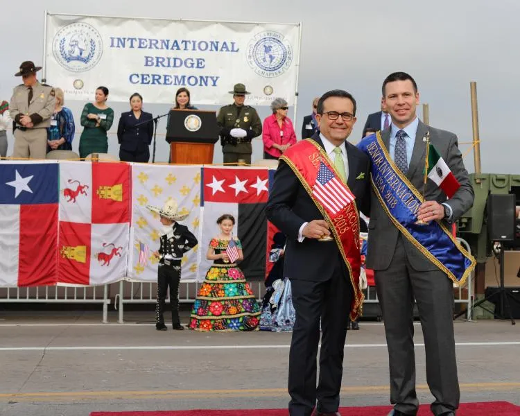 CBP Commissioner Kevin McAleenan poses with Mexico's Ministerio de Economía Ildefonso Guajardo Villarreal, both honored as Señores Internacional in 2018 after exchanging flags and abrazos at the International Bridge Ceremony 