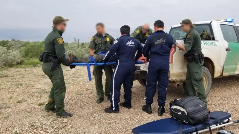Laredo Sector paramedics render First Aid to an undocumented alien who bacem lost at a anch northwest of Laredo