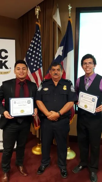 High school students Joshua Duque, left and Leonardo Escamilla, from United South and Cigarroa High Schools, respectively pose with Assistant Port Director Frank Garcia during the Port Director for Day event hosted at Laredo Port of Entry