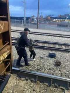 CBP Officer removing child from train.