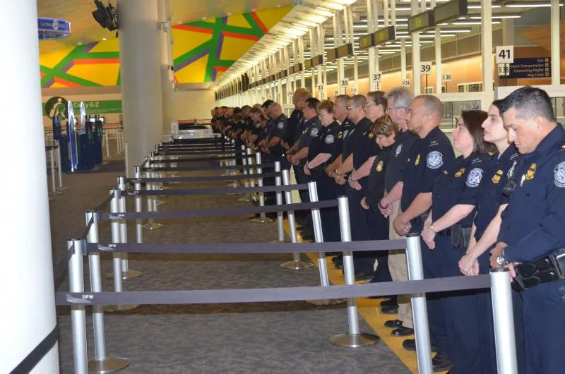 CBP officers stand in line