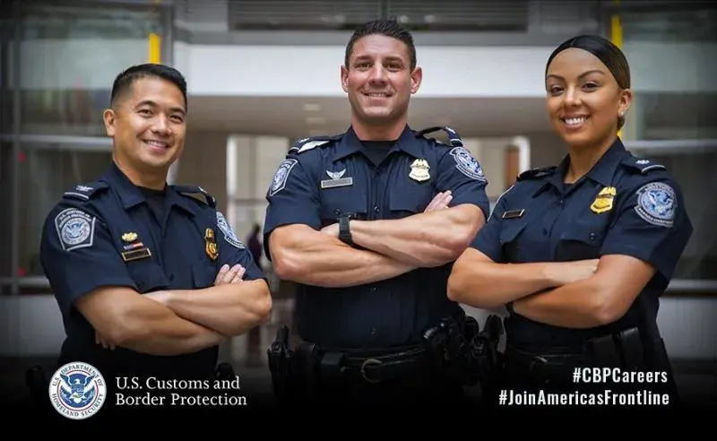 CBP recruiting poster showing three officers standing together with folded arms