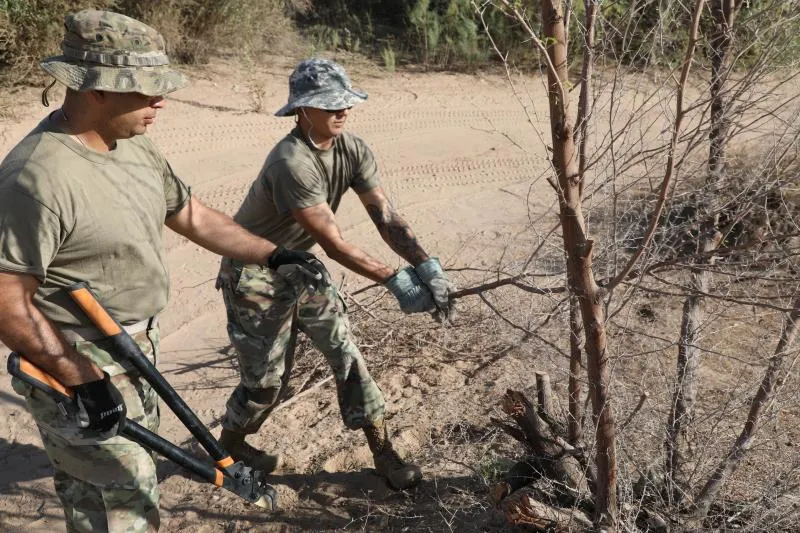 An Operation Guardian Support vegetation crew clears brush near the U.S./Mexico Border in Yuma, Arizona