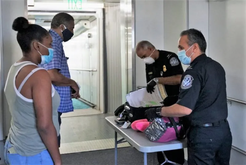 CBP officers with travelers at a Preclearance facility