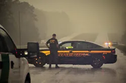  A Border Patrol agent talks with a local sheriff’s department official during a road closure in areas ravaged by Hurricane Florence.