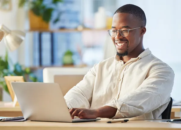 Man typing on his laptop