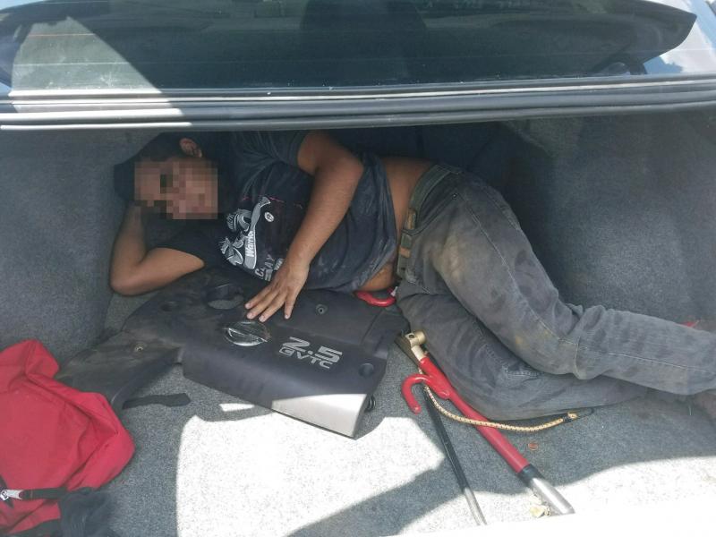 Man hiding in vehicle trunk