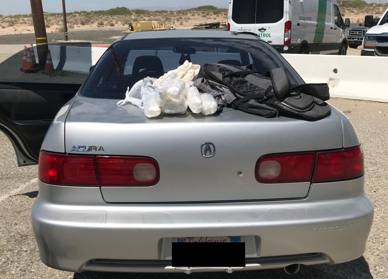 Agents discovered a black and grey backpack on the rear seat of the vehicle with seven wrapped packages inside.  The substance inside the packages tested positive for the characteristics of methamphetamine.