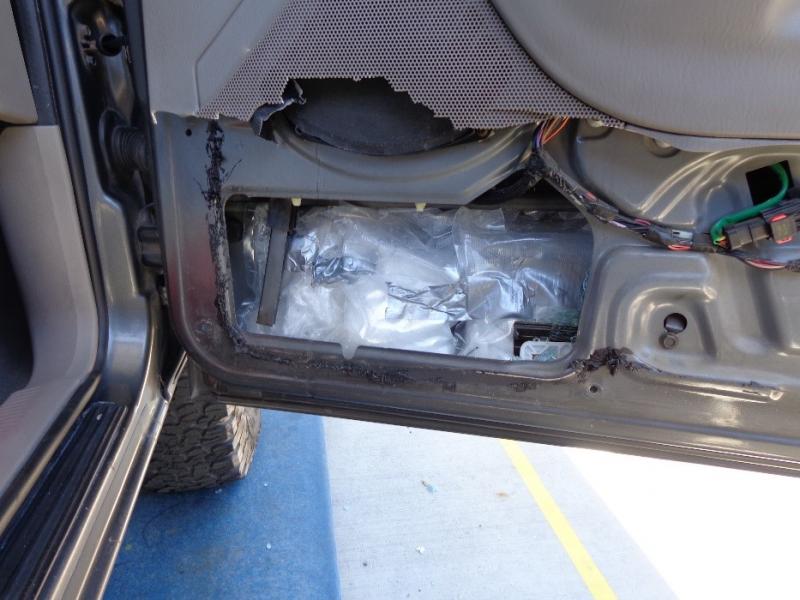 Agents searched further and discovered 98 vacuum-sealed baggies packed inside the front passenger door, the left and right rear doors, the left and right rear quarter-panels, the spare tire, and the rear cargo door.  