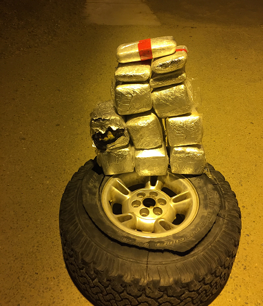 Agents found 12 packages of cocaine and methamphetamine stuffed inside a truck’s spare tire.