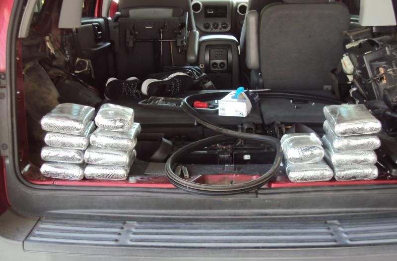 Following a K-9 alert, agents discovered 14 bundles of cocaine and two bundles of heroin hidden in the rear of the vehicle.