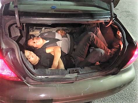 Agents discovered two Mexican nationals inside the trunk of a Tucson woman's car, when searching it at the I-19 immigration checkpoint