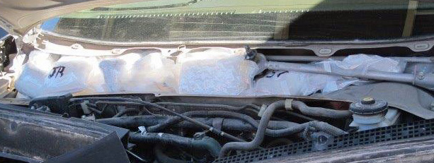 Photo-CBP officers at the Port of San Luis located and seized 56 packages of heroin and meth from a smuggling vehicle