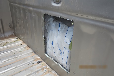 Officers discovered packages of meth within the back wall of a smuggling vehicle