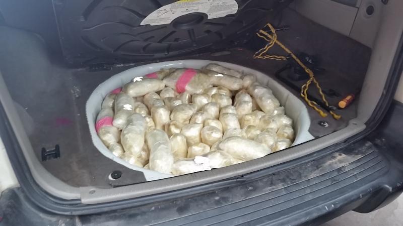Officers discovered almost 107 pounds of meth from the trunk of a smuggling vehicle