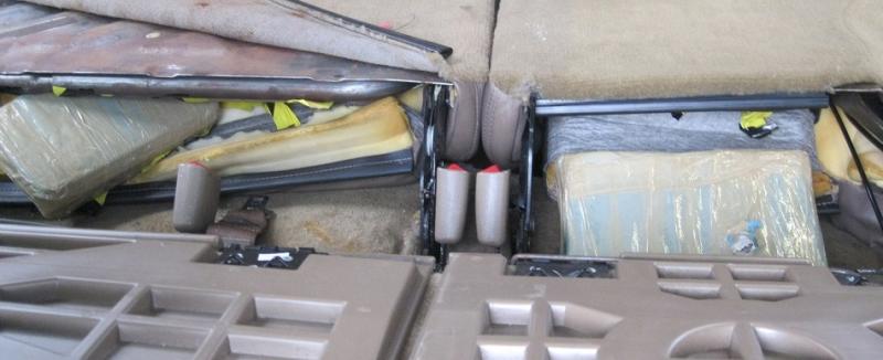 When officers took apart the seats of a smuggling vehicle, they located a total of eight packages of drugs