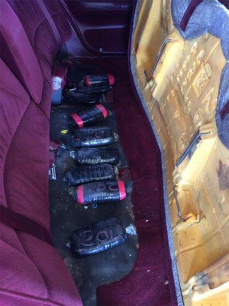 Agents found 10.9 pounds of heroin with an estimated worth of $227,700 hidden under the back seat of the vehicle.