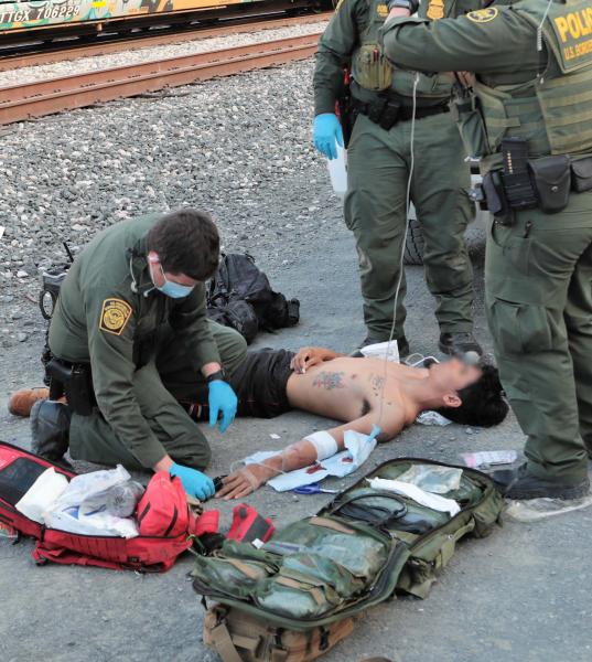 A Border Patrol EMT provides medical care to a man found locked inside a railcar.