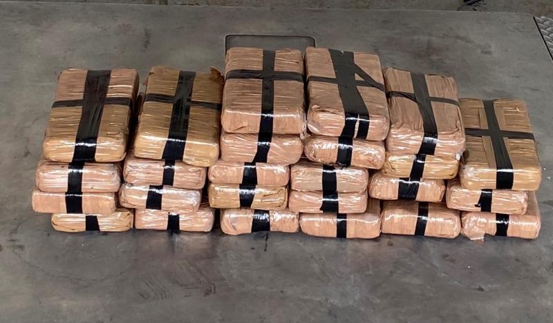 Packages containing more than 59 pounds of cocaine seized by CBP officers at Pharr International Bridge within a tractor.