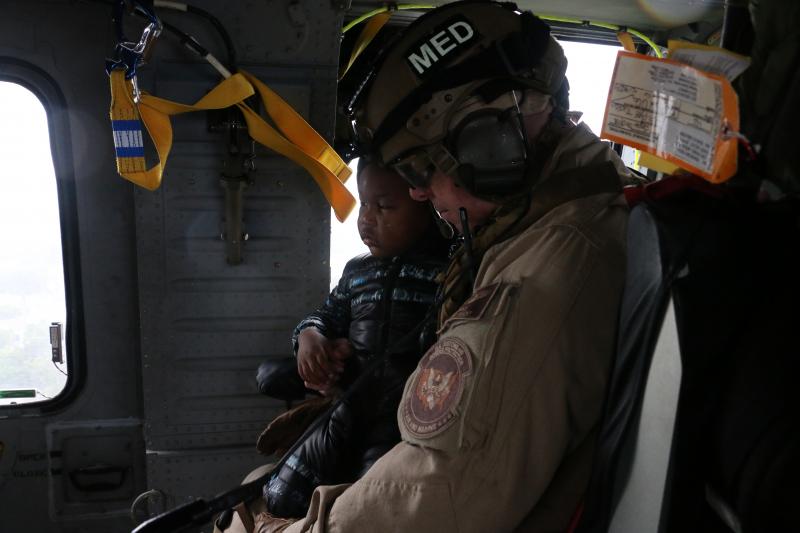 AMO Air and Marine Emergency Medical Services crew members transport a four-year-old male criticla care patient from a flood-impacted Beaumont hospital to another medical facility