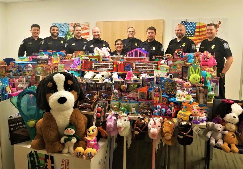 CBP officers stand with collected toys