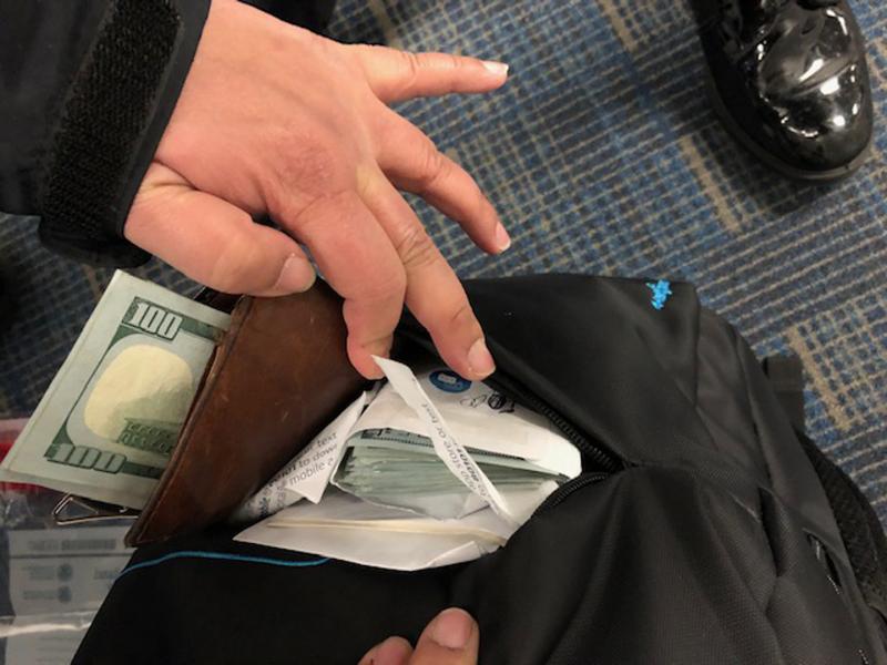 CBP officers discover unreported currency in a traveler's backpack.