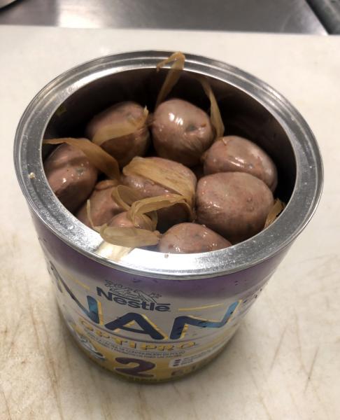 CBP agriculture specialists discovered pork sausage links in baby formula cans.