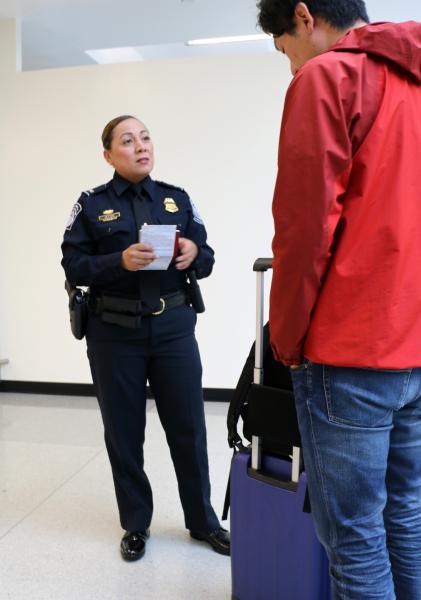 CBP officer interviews a traveler