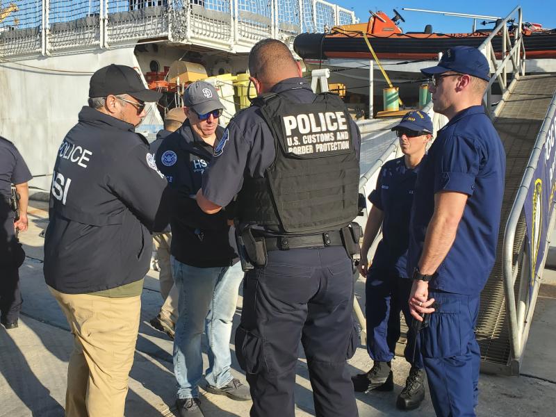 CBP Officers, HSI Agents and Coast Guard staff prepare to offload over 1400 kilos of cocaine from a cutter
