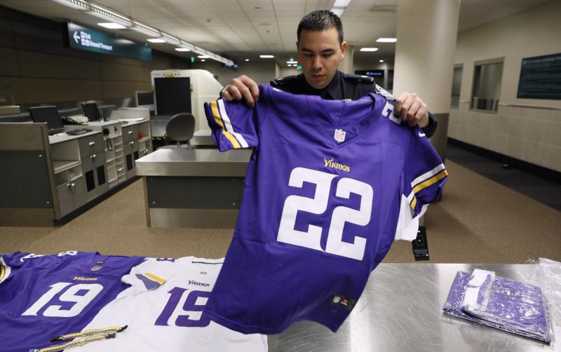 A CBP Officer displays a counterfeit NFL jersey seized as part of an enforcement operation during Super Bowl 52.