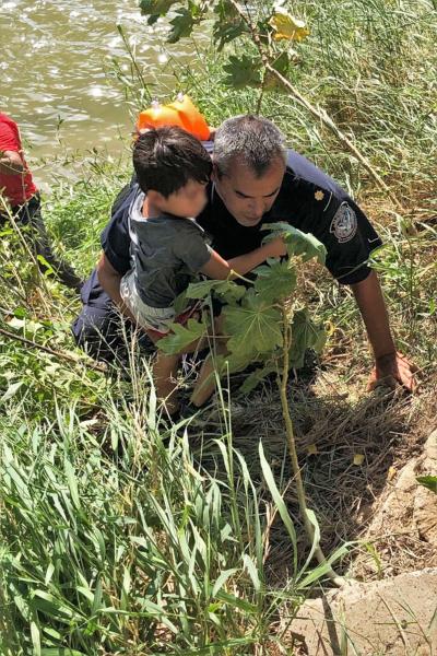 A Border Patrol agent examines a child's medical condition