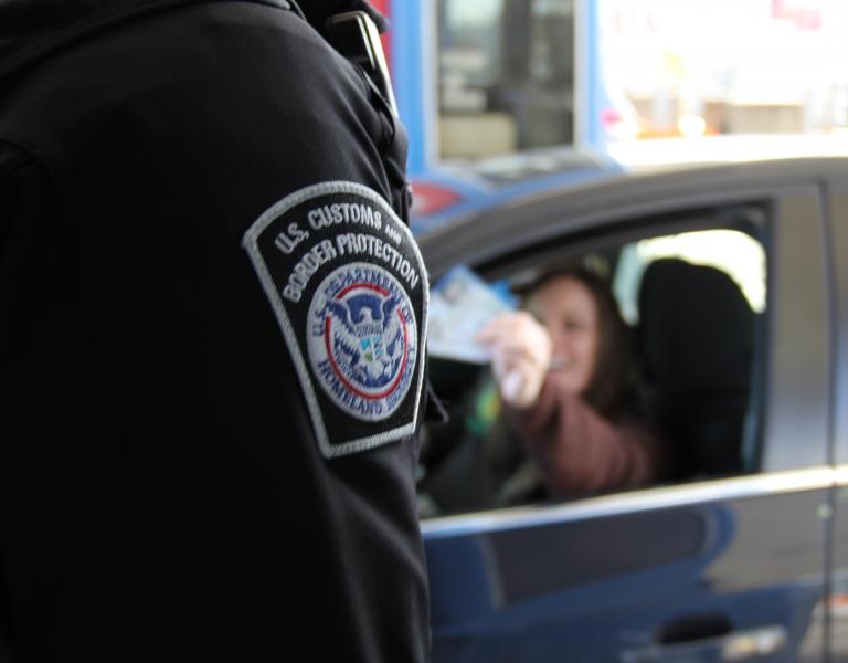 CBP offcer inspects travel documents