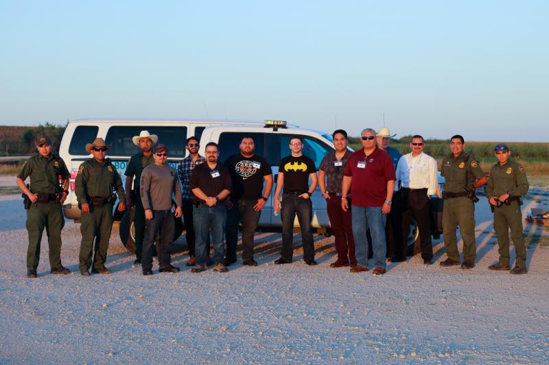 Weslaco Border Patrol agents and Citizen Academy participants standing in front of Border Patrol vehicle