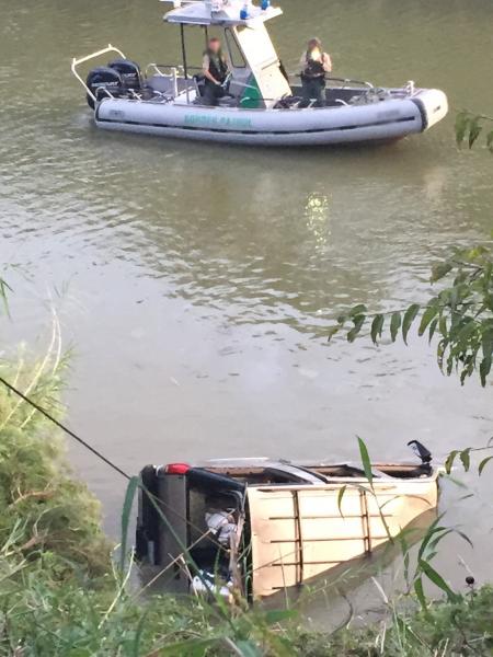 A local wrecker removes SUV from the Rio Grande